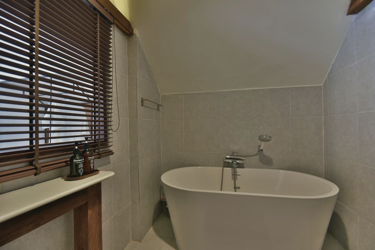 CHANS Suite bathroom with freestanding tub under the eaves
