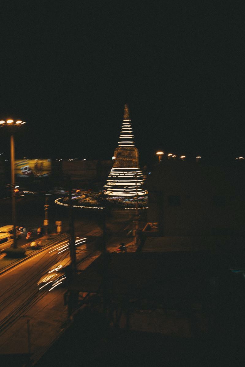 The lit chedi seen across the street at night