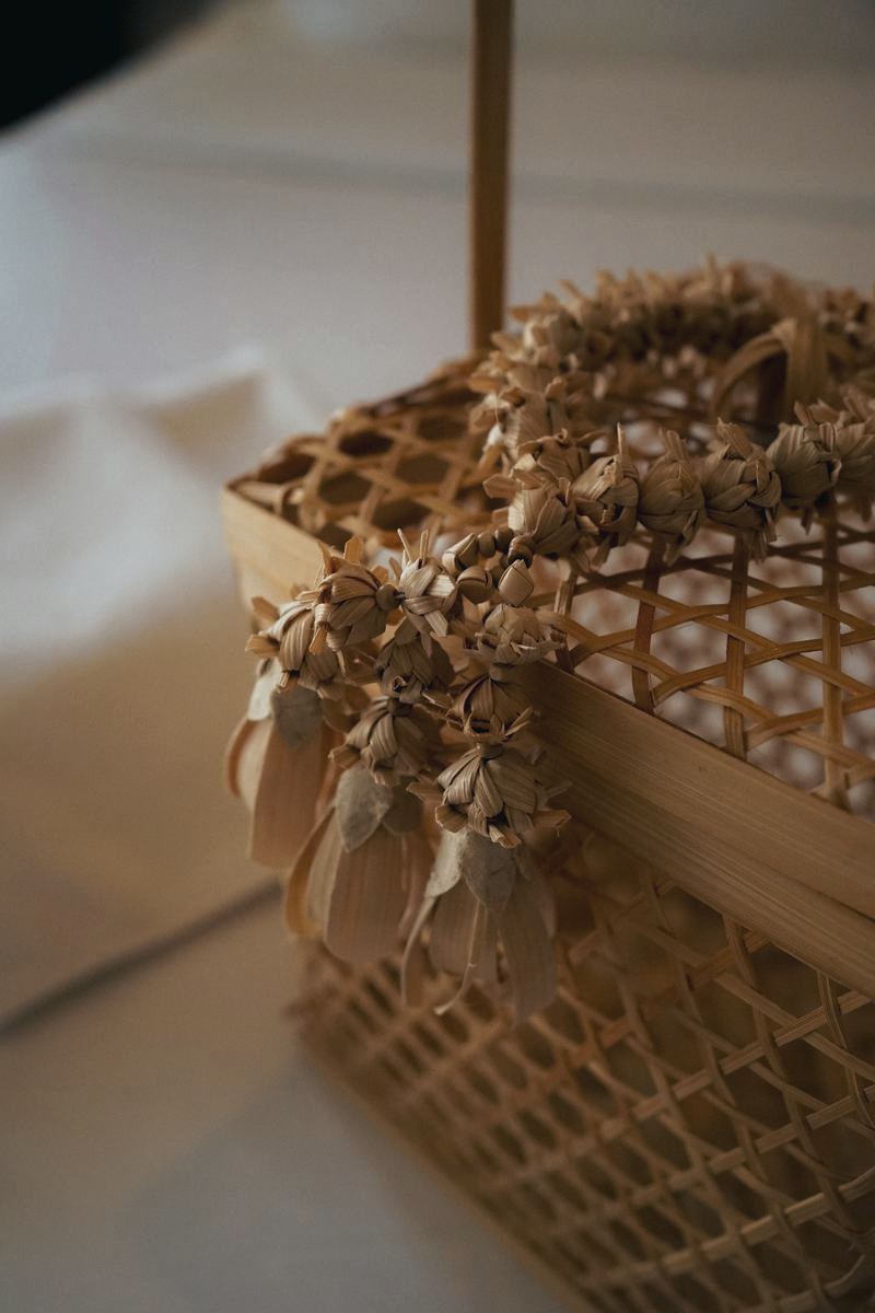 Woven basket with a garland on crisp white linen